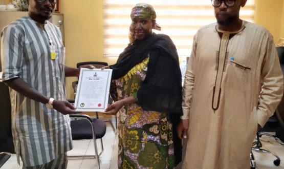 Acting Executive Director, NIWRMC, Mrs. Sakinatu Suleiman Abbo Jimeta (M) making presentation of the Water Use Licence to Rabiu Maska, the Social Performance Specialist, BUA Cement (L), flanked by the Director, Allocation and Authorization, Engr. Shazali Uba Ajingi (R) in Abuja